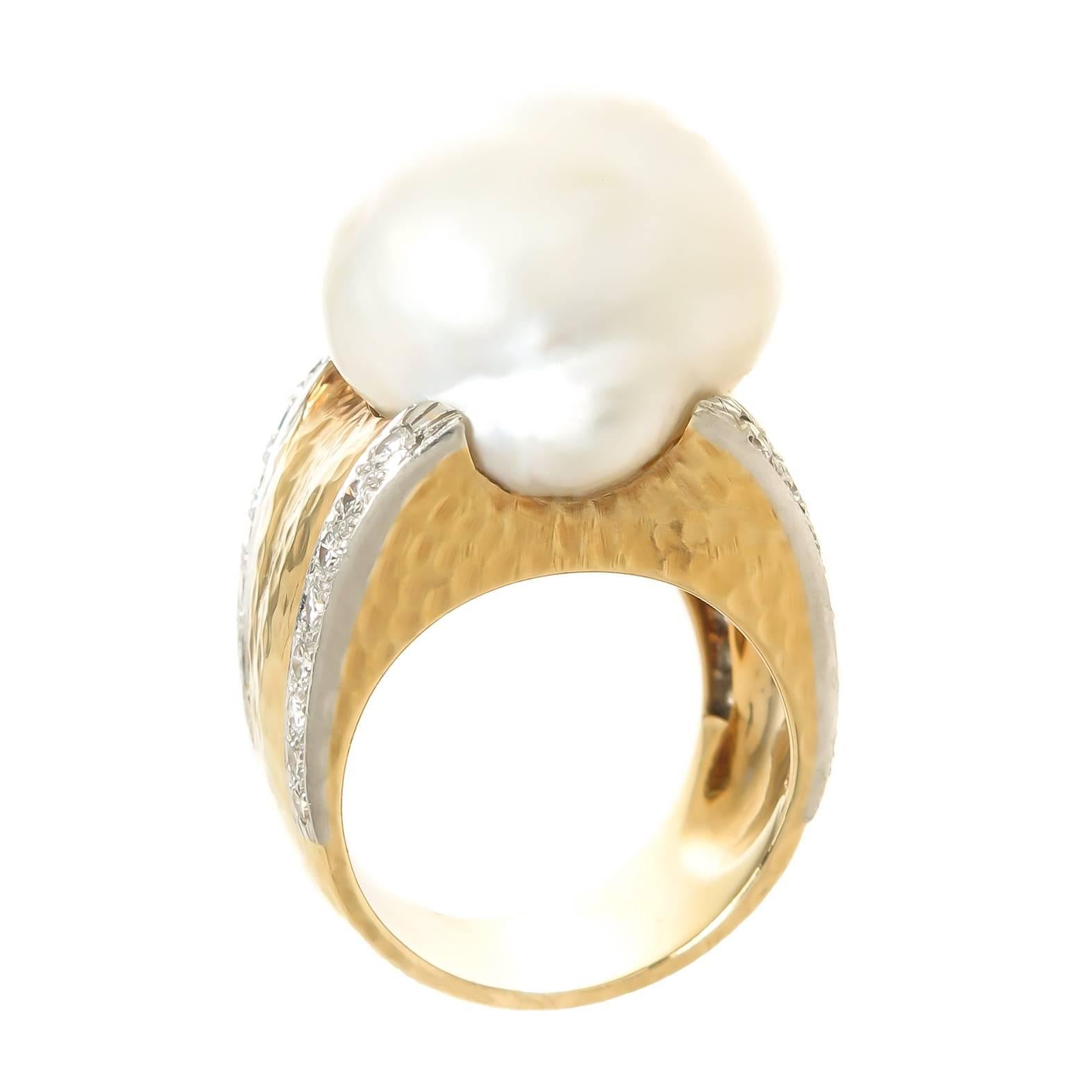 Circa 1990 David Webb 18K Yellow Gold and Large Pearl ring, centrally set with a Natural fresh Water Pearl measuring 21 X 17 X 12 M. M.  Further set with 32 Round Brilliant cut Diamonds totaling approximately 1 Carat, the ring has a hand Hammered