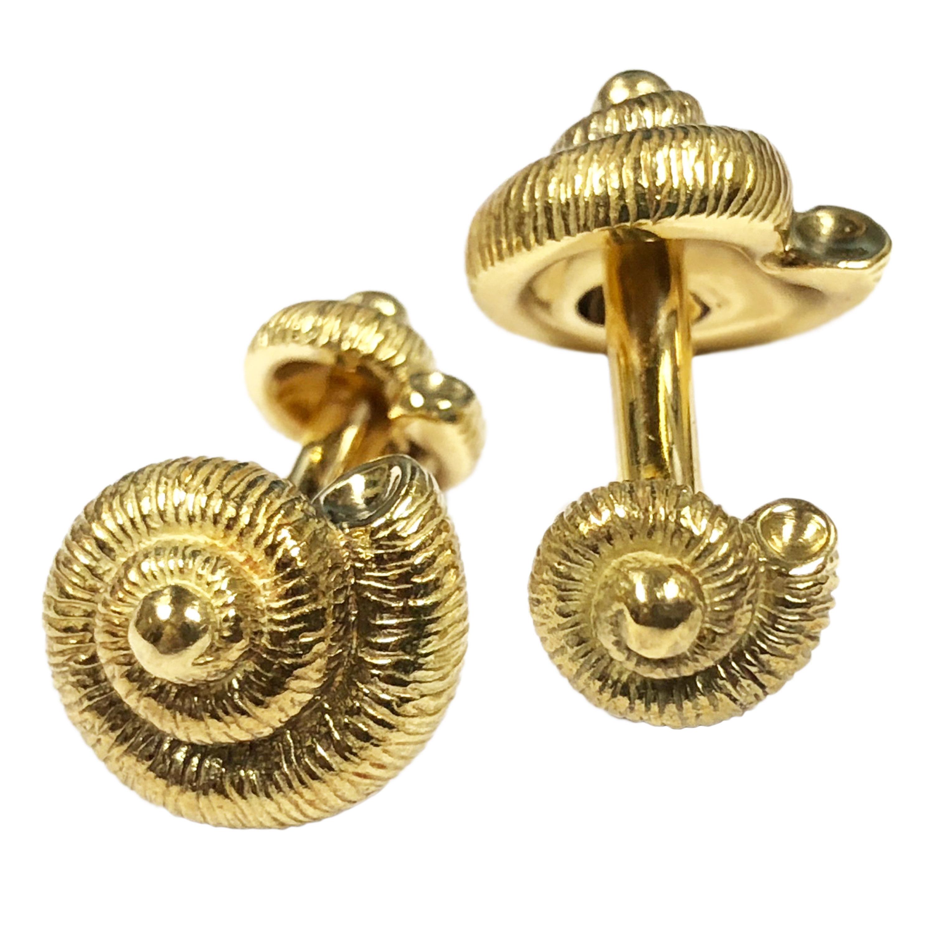 Circa 1990 Tiffany & Company 18K Yellow Gold Turbo Shell Cufflinks, having a finely detailed textured finish, measuring 5/8 inch in diameter and weighing 23.4 Grams. Excellent near unworn condition and come in a Tiffany Gift box with Suede travel