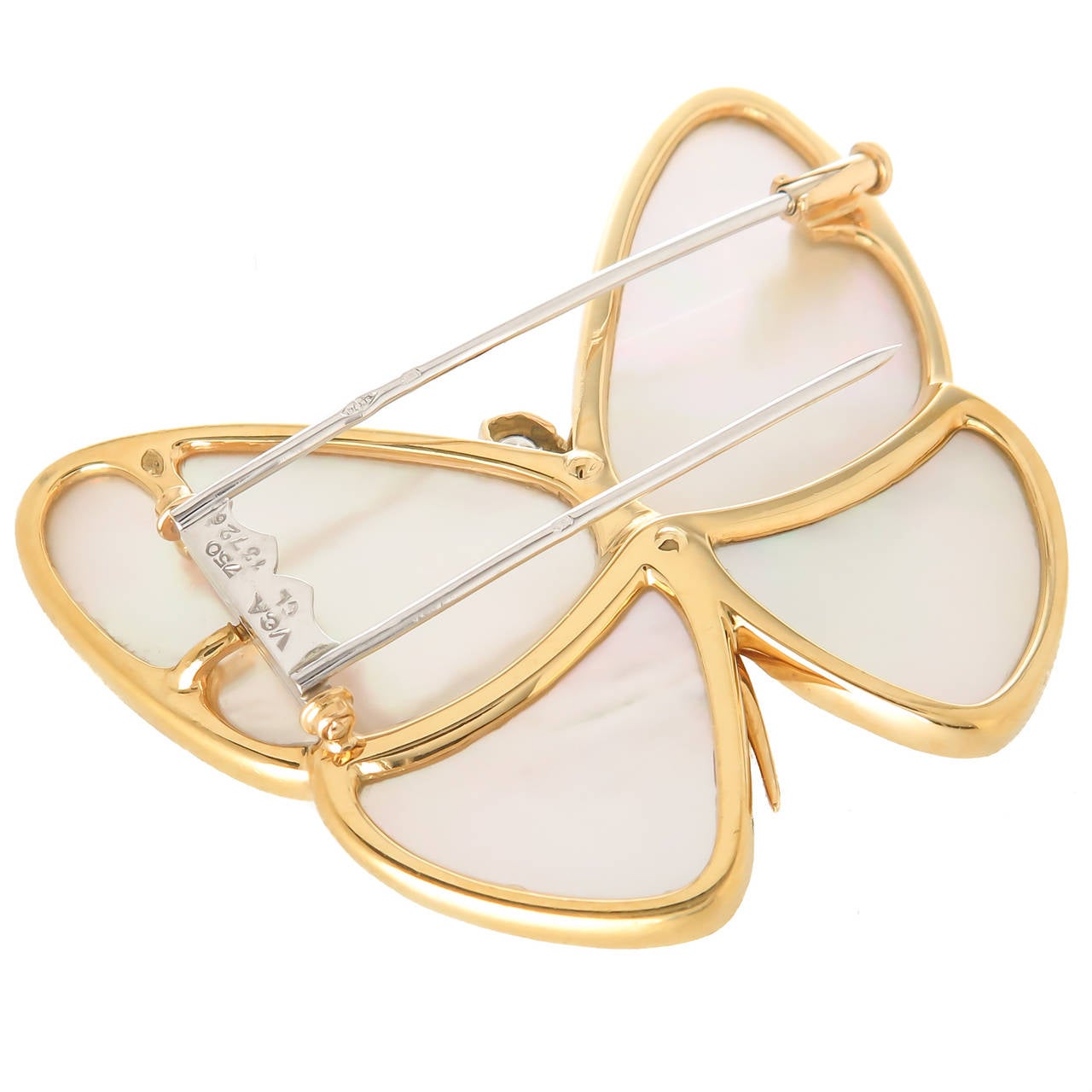 Circa 2010 Van Cleef & Arpels Butterfly Brooch, 18K yellow gold and White Mother of pearl, set with 9 graduating round Brilliant cut Diamonds totaling .40 carat. Measuring 1 7/8  inch  x  1 5/8 inch. Double Clip back, signed, numbered and having