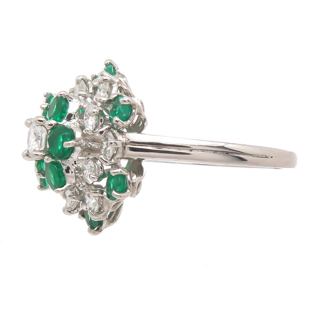 Circa 1990 Platinum, Diamond and Emerald Ring by Oscar Heyman, Set with Very fine round Gem color Emeralds and alternating with Round Brilliant cut Diamonds totaling 1 Carat. measuring 1/2 inch in diameter, finger size = 6