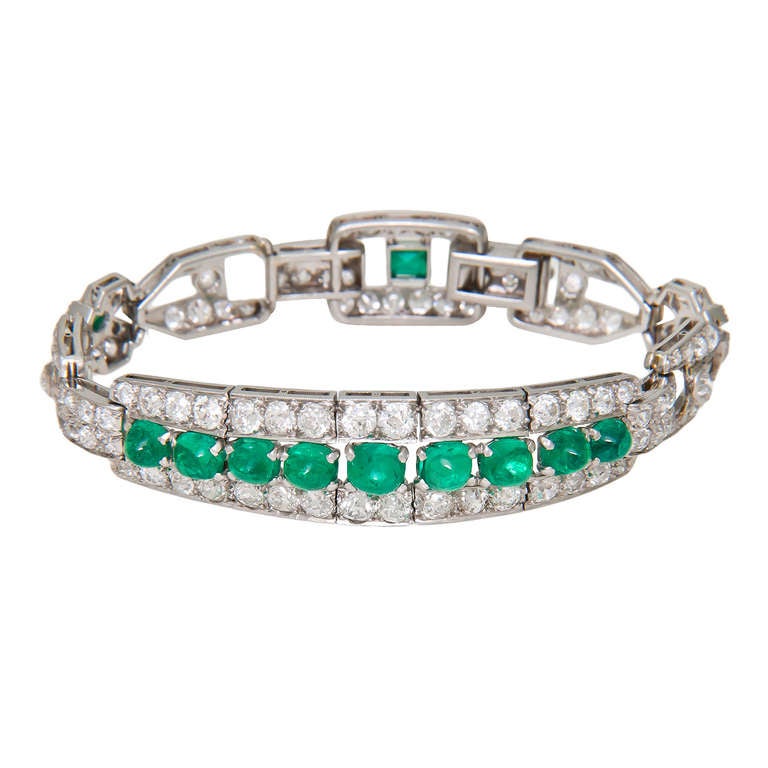 Circa: 1930s Art Deco platinum Bracelet set with 7 carats of old European cut Diamonds and Cabochon and Cushion Emeralds. A very well made bracelet with nice Clean White Diamonds and very Good Color Emeralds.