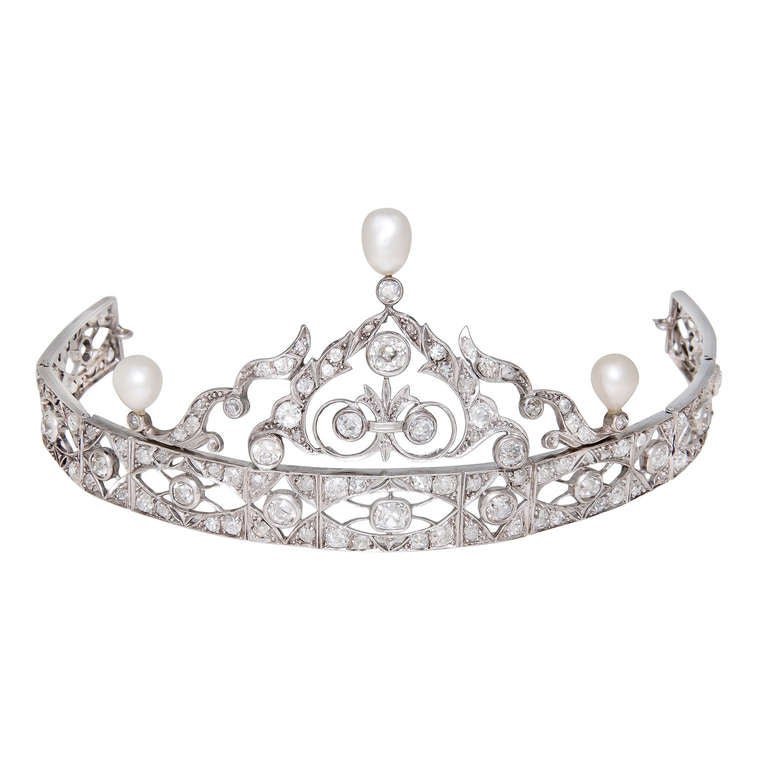Circa: 1920s Platinum, Diamond and Pearl Tiara, once belonging to and worn by Zsa Zsa Gabor. Having flexible sections, the Tiara has rings on each end where it is attached to the hair by hair pins. Set with 11.50 carats of Old European and cushion