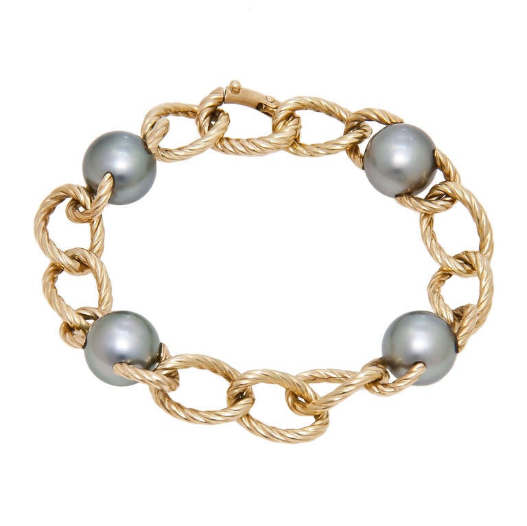 18K Yellow Gold and 10 M.M. Grey Tahitian Pearls Bracelet. Twisted gold Links. Original Suede Pouch.