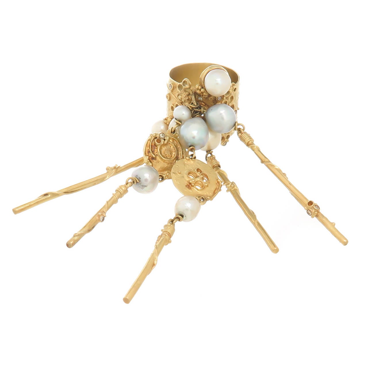 Circa 1990 18K Yellow Gold, Pearl and Diamond Ring by Artist Gerda Flockinger. A wide band ring with hand worked textures with attached dangling sections measuring 2 inch in length, set with various sizes and colors of cultured Pearls and further