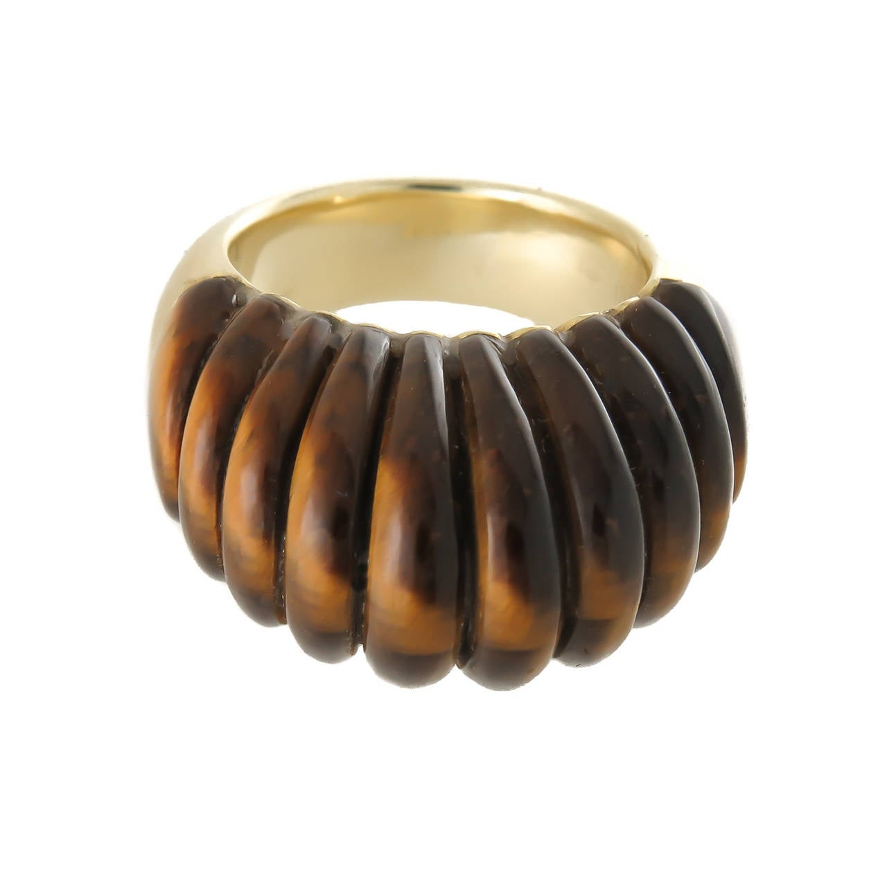 Circa 1970s 18K Yellow Gold Ring by Gucci, the top being a solid piece of Scalloped Tigers Eye in a high dome. Top measurements 1 inch across and 3/4 inch high.  Finger size = 5