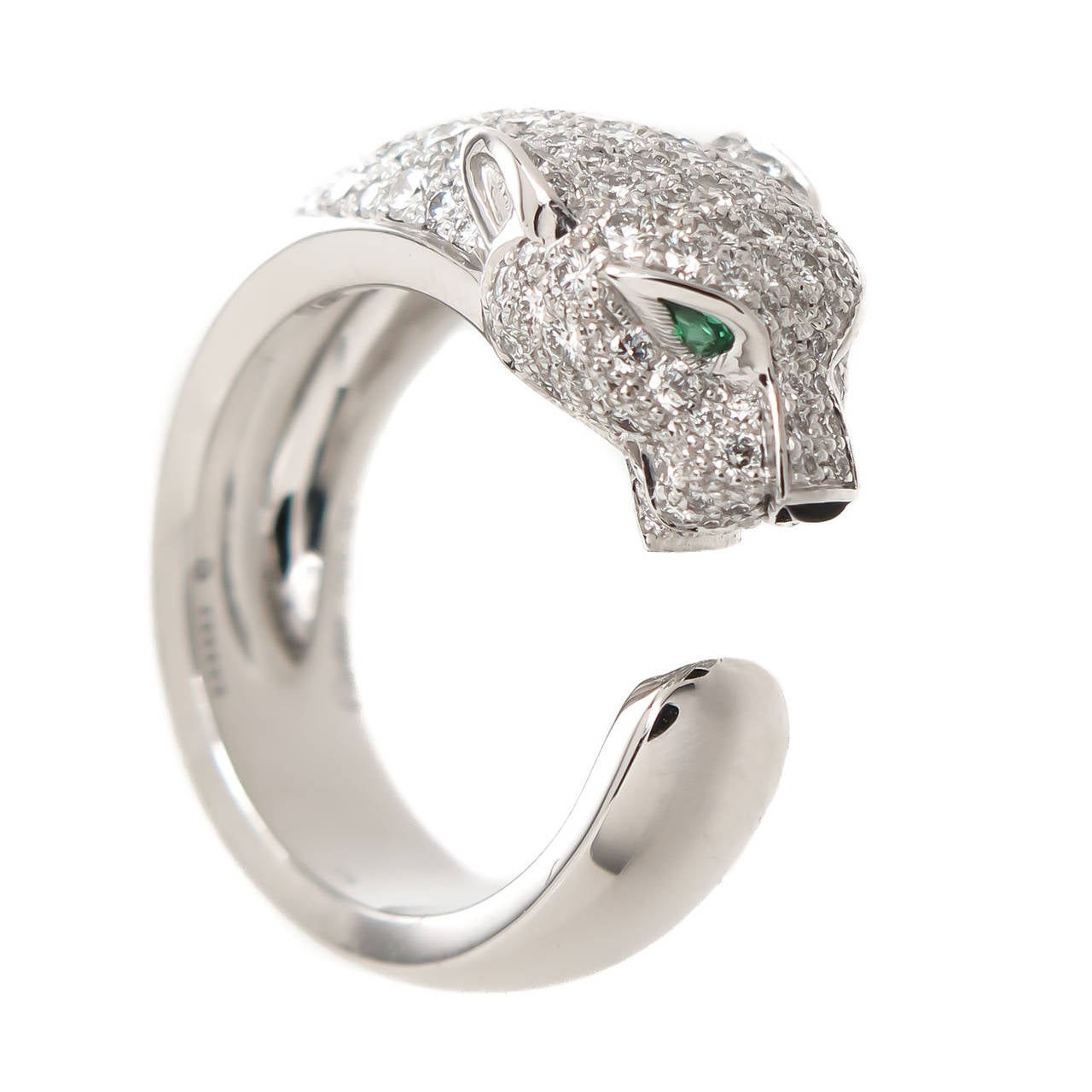 Circa 2012 Cartier 18K White Gold and Diamond ring from the Cartier De Panthere Collection. Set with 1.50 Carats Fine White, Round Brilliant cut Diamonds and further accented with Emerald Eyes and an Onyx Nose. Finger size = 6  ( 52  European ) 