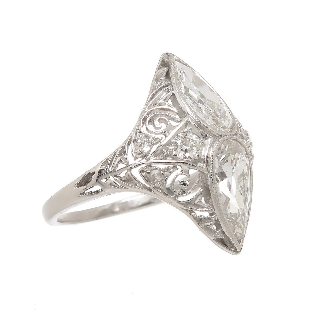 Circa 1920s Edwardian Filigree Platinum Ring, centrally set with 2 Pear Shape Diamonds  that are of old European cut with open Culets, both stones are H-I in color and VS in Clarity and measure approximately 8 x 4 MM and are .75 to .80 each for a