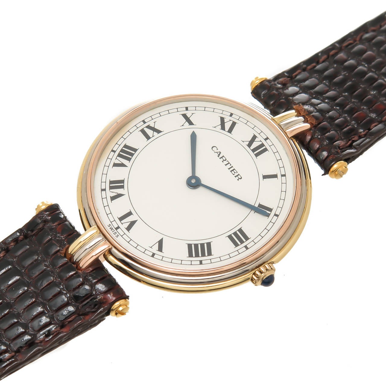 Circa 1990 Cartier 18K Yellow, White and Rose Gold Vendome, Trinity Watch. 2 piece 30 MM water resistant case, Quartz Movement, White Dial with Roman Numerals, Sapphire Glass Crystal and a Sapphire set crown. New Brown Lizard strap with a Gold Plate