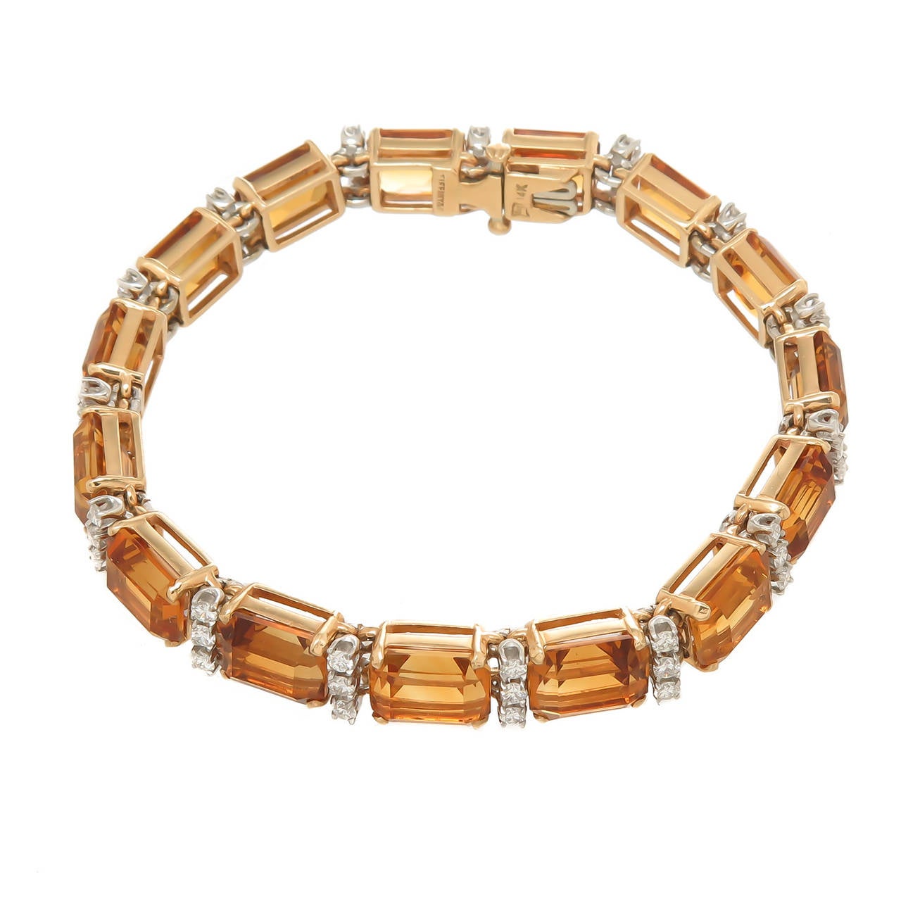 Circa 1980s Tiffany & Company 14K yellow Gold, Citrine and Diamond Bracelet. Set with 15 step cut Golden Citrines totaling approximately 40 Carats and Round Brilliant cut Diamonds totaling 1.45 Carats. Measuring 6 3/4 inch in length and just over