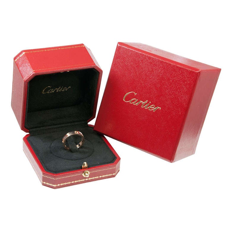 Cartier 18K Pink Gold and 5 Diamond Love Ring, 4 M.M. wide, Finger size = 6 1/2 ( 54 ) Comes in Original Gift Box.