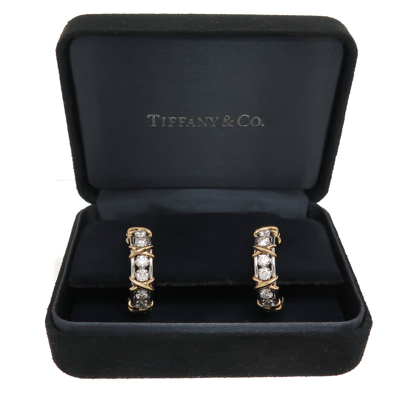 Circa 2005 Jean Schlumberger for Tiffany & Company X Hoop Earrings, 18K Yellow Gold with Diamonds set in Platinum. Containing 20 Round Brilliant cut fine White Diamonds totaling 1.80 Carats. Measuring 7/8 inch in length and 3/16 inch wide. In