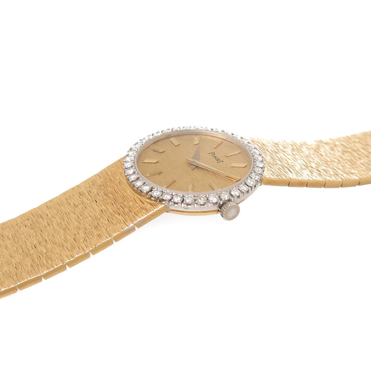 Rare Mint Condition With Original Box Circa 1970s Piaget 18K Yellow Gold and Diamond Ladies Bracelet Watch. The Round Watch Measuring 25 MM and attached to a 7 inch, fine mesh link Bracelet that measures 5/8 inch wide. The White Gold Bezel is set