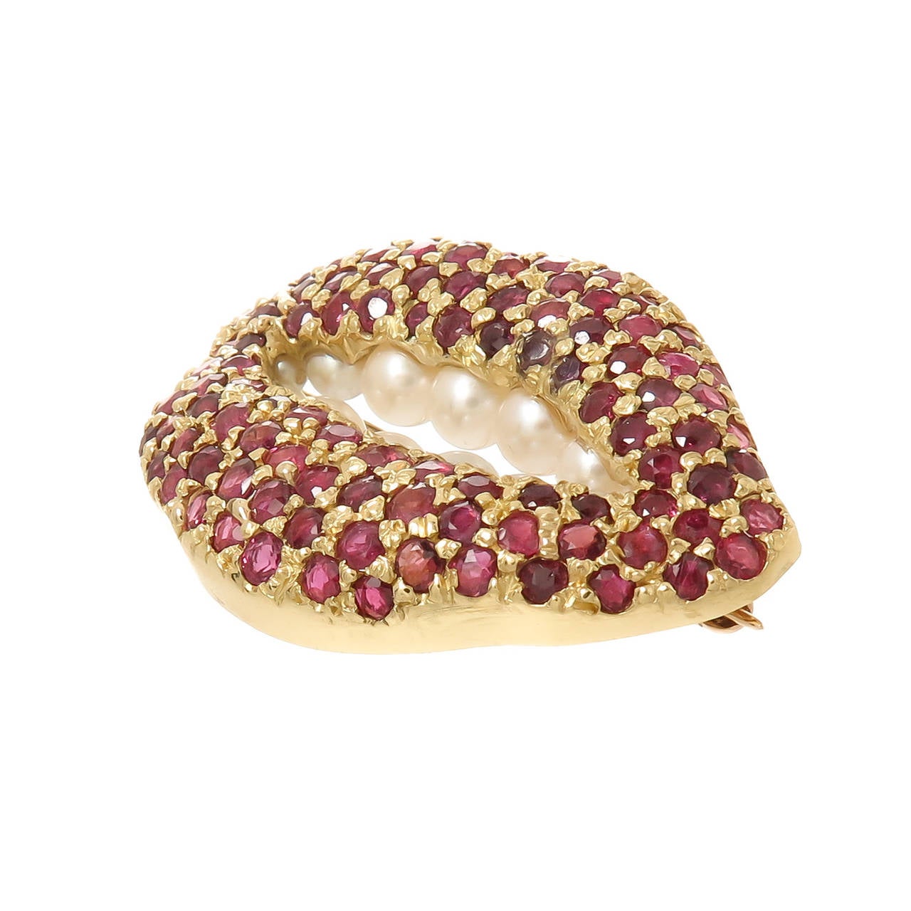 Circa 1980 18K Yellow Gold, Ruby and Pearl Lips Brooch by Salvador Dali and made by Henryk Kaston, set with just over 100 Round Rubies totaling approximately 4 to 5 Carats that are of fine matched deep Red Color, further set with 13 Cultured Pearls