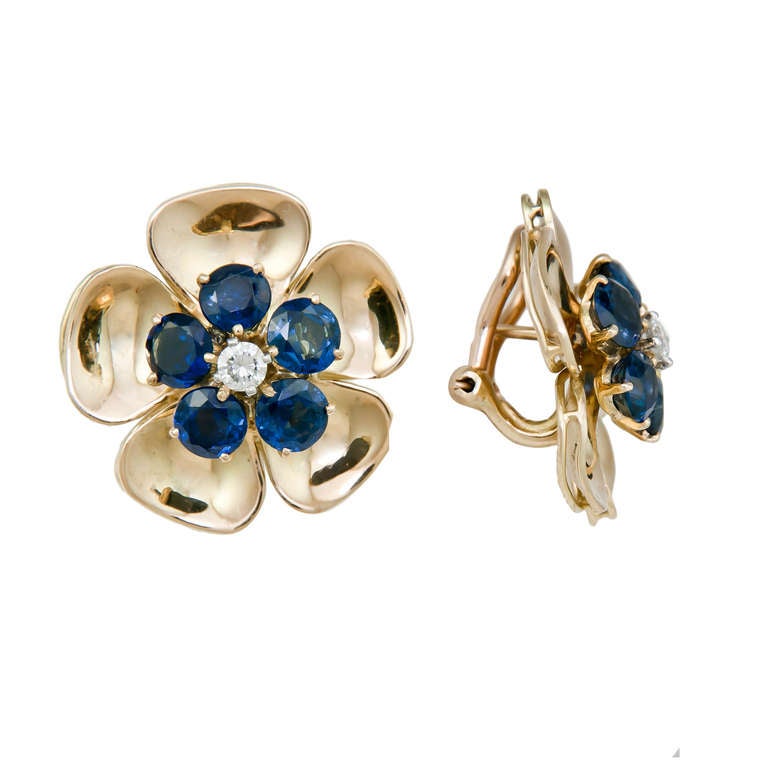 Circa 2000 Very Elegant Flower Form Ear Clip Earrings, 18K Yellow Gold and Having very High Polished Pedals to give Reflective Depth. Set with Round Brilliant cut Sapphires of Very Fine Color and Centrally set with a .10 Carat Diamond. Post Backs