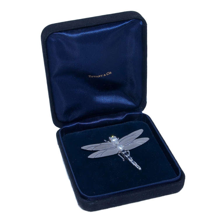 Tiffany & Co. 18K White Gold Dragonfly Clip Brooch, Very Detailed with a Light frosted finish on the wings and set with Diamonds and Pearls. Comes in Original Tiffany & Co. Presentation Box.