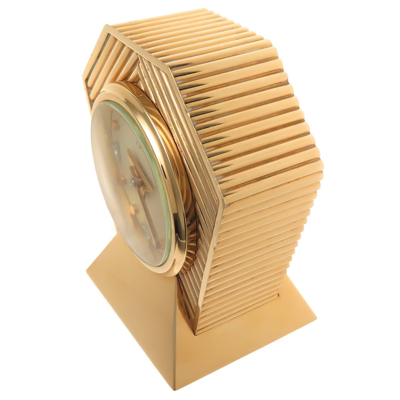 Circa 1953 Cartier 14K Yellow Gold Desk Clock. Art Deco, Streamlined Ribbed Case, Concord, Manual Wind Movement. Cream Color Dial with Raised Gold Button Markers and Diamond Set markers.Gold Arrow Shape Hands with a Diamond set in the center. Signed