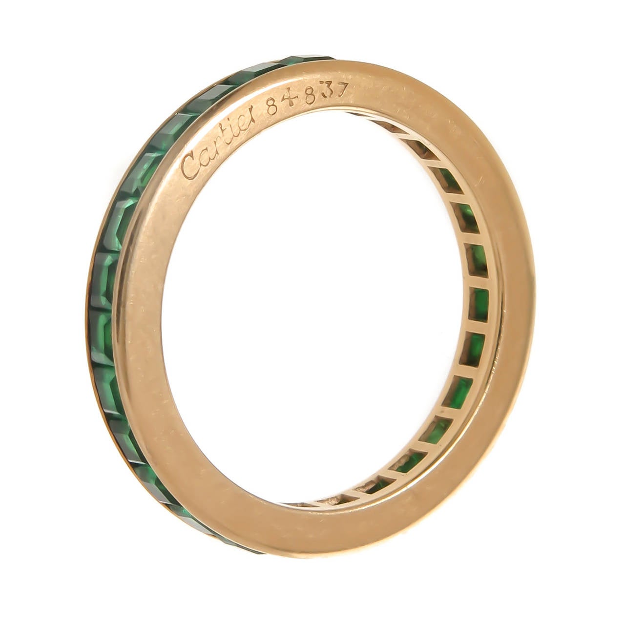 Circa1980s Cartier 18K Yellow Gold and Square cut Emeralds eternity band ring, Measuring 2.5 MM wide, the Emeralds are of very fine Deep Rich Colombian Color. Signed, Numbered and in the original Cartier Presentation box. Finger size = 5 1/2