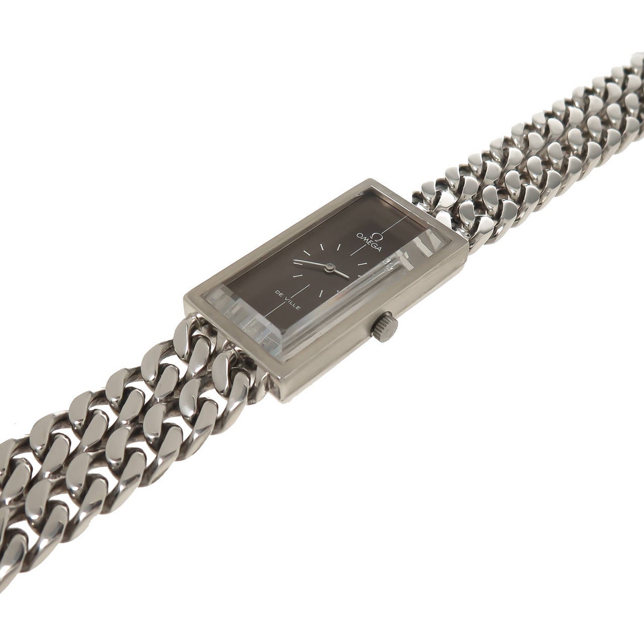 Circa 1970 Omega DeVille Sterling Silver Wrist Watch, 2 piece case measuring 1 1/2 inch in length X 7/8 inch wide and attached to a double row sterling silver link bracelet with Omega logo on the slide lock buckle. Total length of watch and bracelet