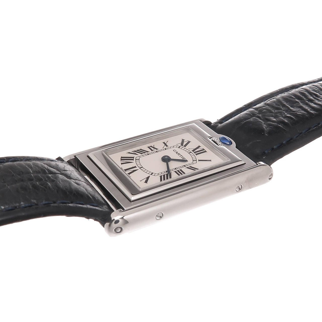 Circa 2005 Cartier Tank Basculante Stainless Steel Reversible Wrist Watch, measuring 1 3/8 inch in length X 7/8 inch wide. Quartz Movement, White dial with Black Roman Numerals and a Sapphire Cabochon set above the crown. New Black Textured Grain