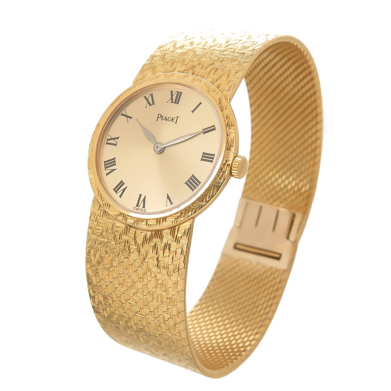 Circa 1970s Piaget 18K Yellow Gold Piaget Ladies Wrist Watch, Manual Wind movement, Gold Dial with Black Roman Numerals, watch measures 25 MM in diameter 6 1/2 inch in length and 5/8 inch wide. The mesh bracelet has a textured finish with a matching