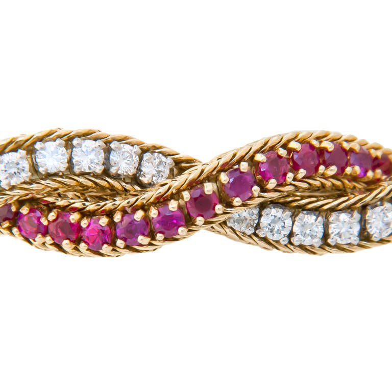 Circa 1960s 18K Yellow Gold, Diamond and Ruby Bracelet by Oscar Heyman Brothers, New York. In a Flexible twist design and set with 4 Carats of Fine White Round Brilliant cut Diamonds. and 4 carats of fine Round Brilliant cut Rubies. Signed and