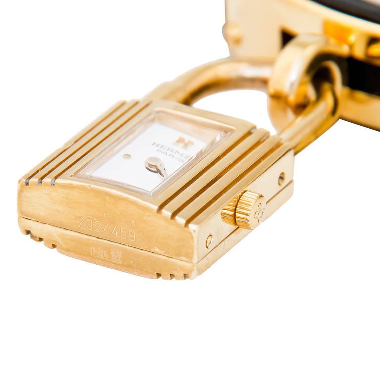 Circa 2010 Hermes Kelly Watch, Gilt Metal Case and fittings, Black Double wrap around strap. Quartz Movement, white dial. Strap looks new and never worn.