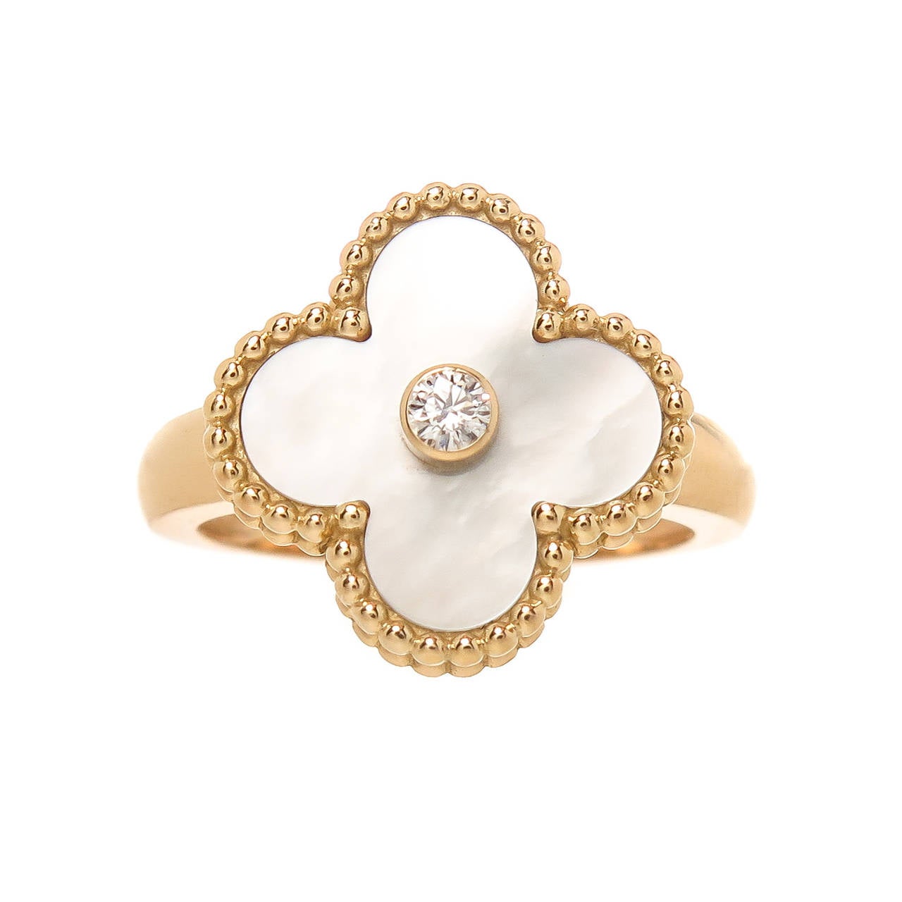 Van Cleef & Arpels 18K Yellow Gold Alhambra Collection ring. Set with White Mother of Pearl and Centrally set with a .05 carat round Brilliant Diamond. Signed and Numbered and having French Control stamps, Finger size = 5 3/4