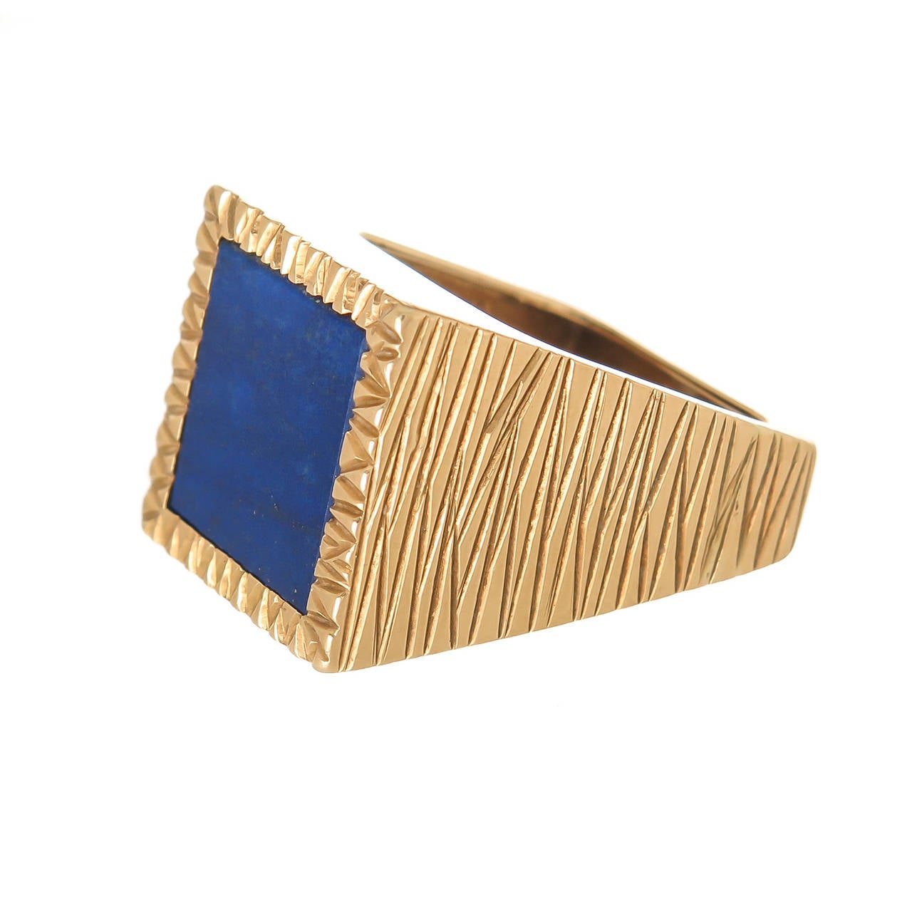 Circa 1970 Andrew Grima 18K Yellow Gold and Lapis Lazuli Ring,  in a square design with textured and smooth sides, teyured top and centrally set with a fine color Lapis. Top measures 3/4  X  3/4 inch. Finger Size = 6 1/2