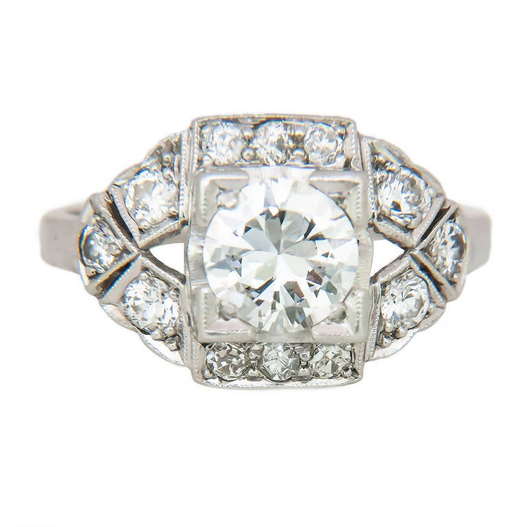 Circa 1920s Platinum and Diamond Engagement Ring, centrally set with a .75 Carat European cut Diamond J in color and SI 1 in Clarity, further set with smaller European Cut Diamonds totaling  1/4 Carat. Finger size = 5 1/2
