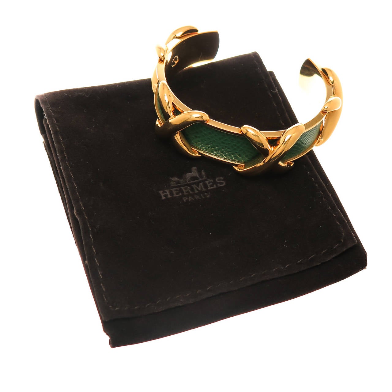 Circa 2010 Hermes Couchevel Cuff Bracelet, Gold plate with Textured Green Leather, measuring 3/4 inch wide and a 1 1/4 inch opening, will fit most wrists. With Original Hermes Pouch.