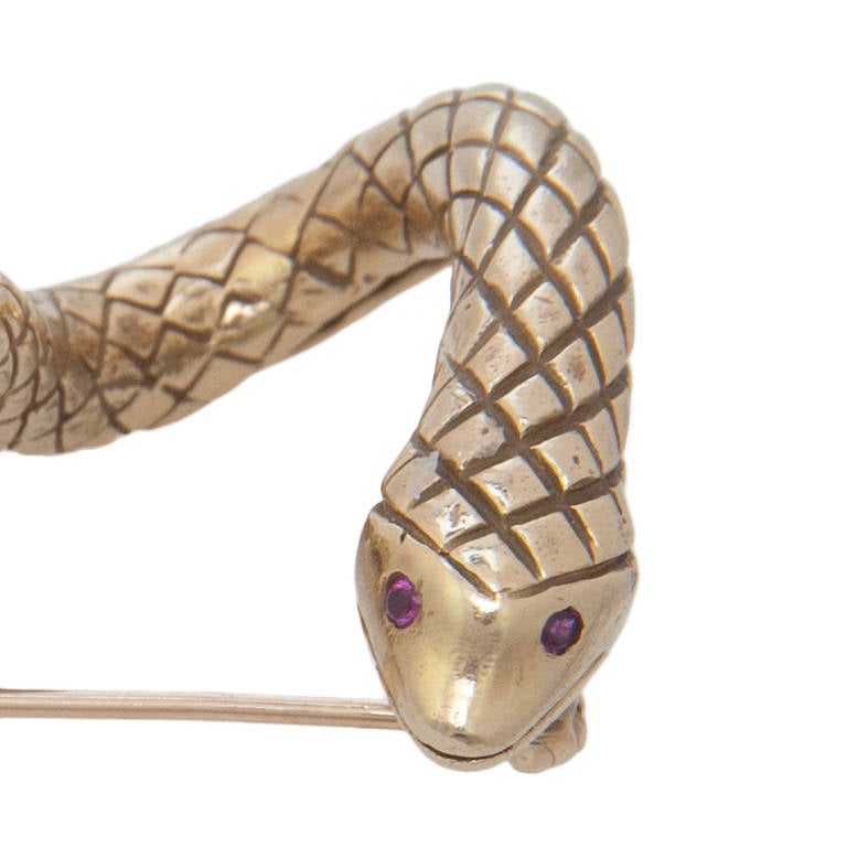 Circa 1980 18K Yellow Gold Snake Brooch by Erwin Pearl. Nice textured finish and set with Ruby Eyes.