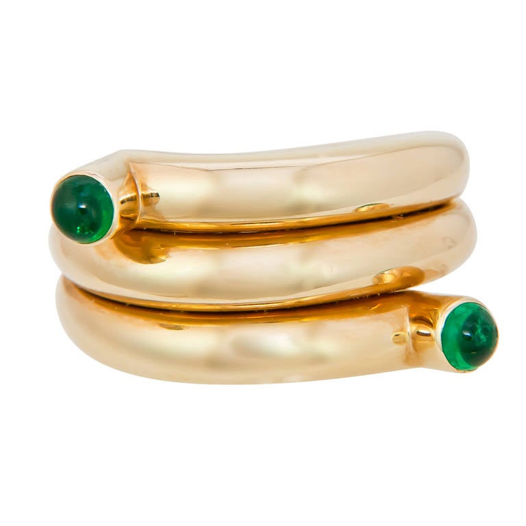 Circa 1990s Double Coil ring by jean Schlumberger for Tiffany & Company, set with 2 fine color cabochon Emeralds. Finger size = 7