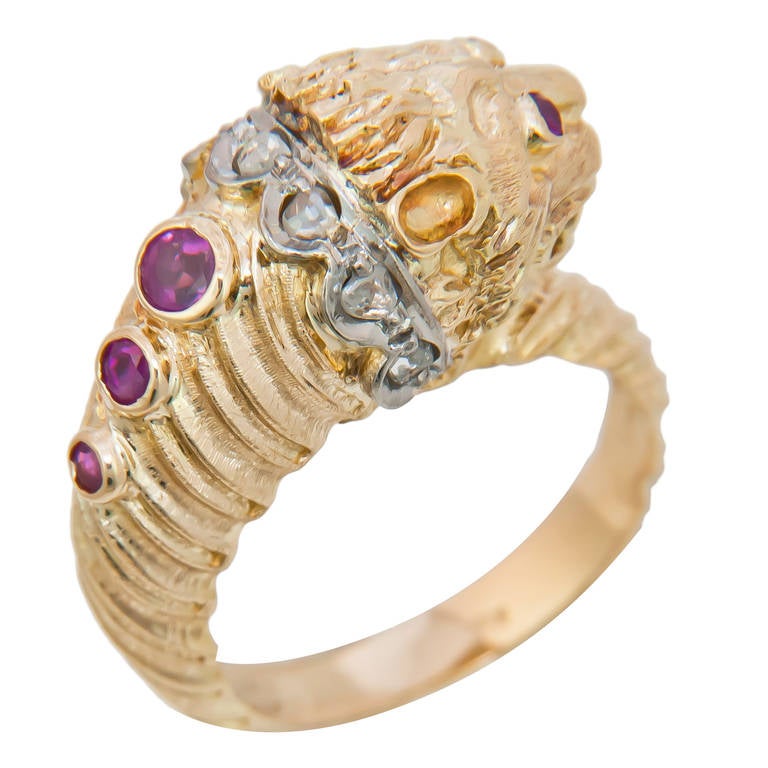 18K Yellow Gold and Gem Set Lion Head Ring by Ilias Lalaounis, nicely detailed and set with Rubies and Diamonds.Stamped Greece and also Bearing the stamp for Lalaounis.  Finger Size = 7
