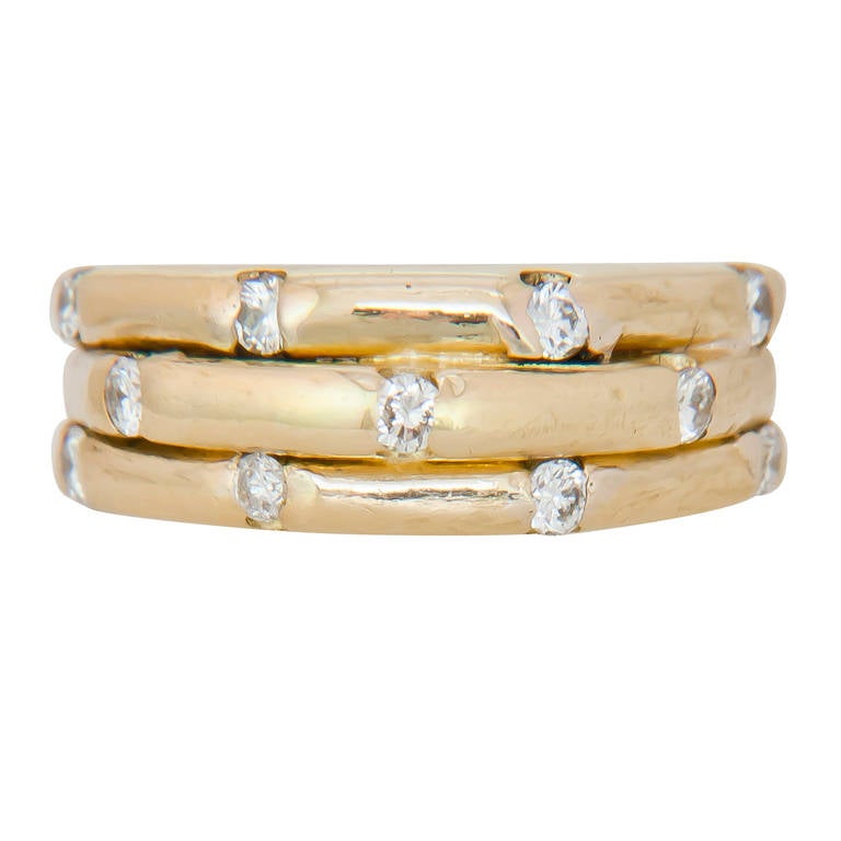 Circa 1980s Tiffany & Company 18K Yellow Gold Bamboo Style Ring. Set with 11 Full Cut Round Diamonds Totaling .25 Carat, 1/4 inch wide, Finger size = 7