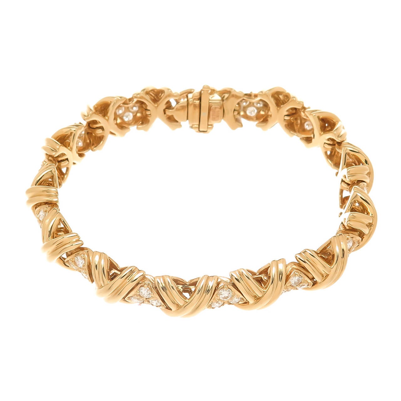 Circa 1990s Tiffany & Company Signature Collection X bracelet, 18K Yellow Gold, Round brilliant cut Diamonds totaling approximately 2 carats and are F-G in Color and VS in clarity. Measuring 7 3/8 inch in length and 3/8 inch wide.