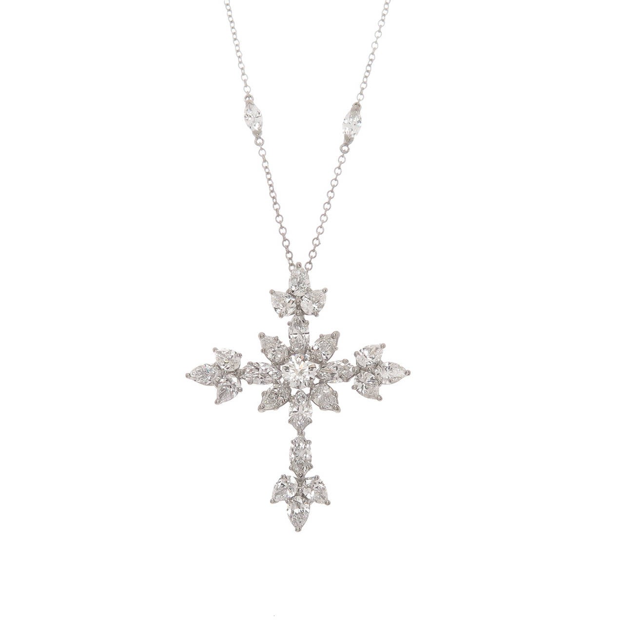 Circa 2014 Harry Winston Platinum mounted Diamond Cross from the Marquise collection. Containing 30 Round, Pear and Marquise shape Diamonds totaling 3.68 Carats, the diamonds all grade as F in Color and VS in Clarity. The cross measures 1 3/8 inch