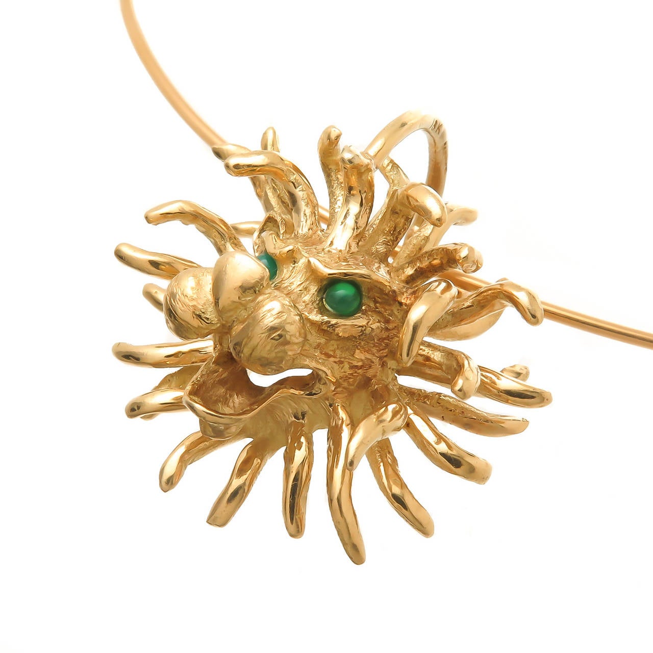 Circa 1970 Cartier 18K Yellow Gold Lion Pendant on an 18K Yellow Gold Cartier wire torque, the pendant is heavy and is nicely detailed and textured and features Green Chrysophrase Eyes. the 2 MM thick Wire measures approximately 16 1/4 inch. In a