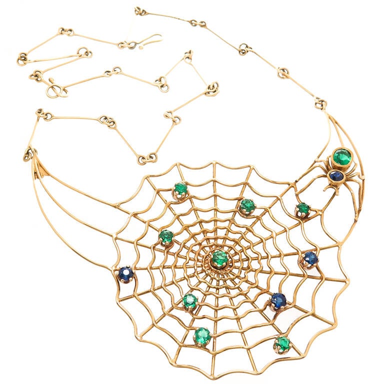 Circa 1970s 18K Yellow Gold and Gem Set Spider Web Necklace, set with nice color Sapphires and Emeralds, this piece measures 18 inch in length with the web portion measuring 3.1/2  X  2 1/4 inch.