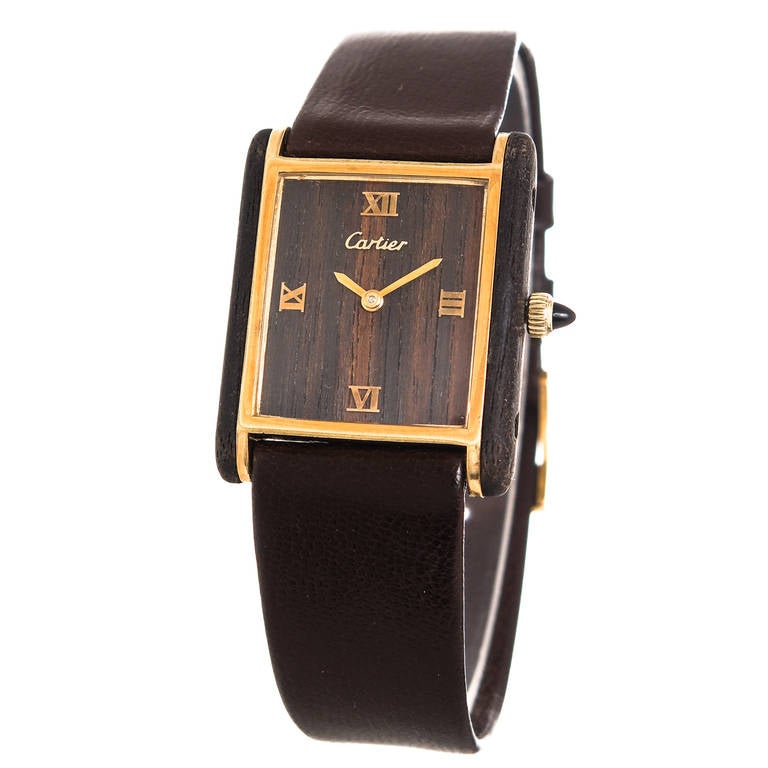 Cartier lady's gilt metal and wood Tank wristwatch, wood dial with gilt markers, manual-wind movement, sapphire-set crown. Original brown Must De Cartier strap and gilt Cartier buckle.