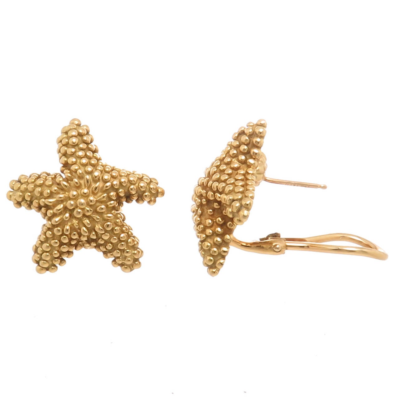 Circa 1990 Tiffany & Company 18K Yellow Gold Starfish Earrings. having a nice textured finish, Omega Clip with posts. measuring 1 inch in diameter.