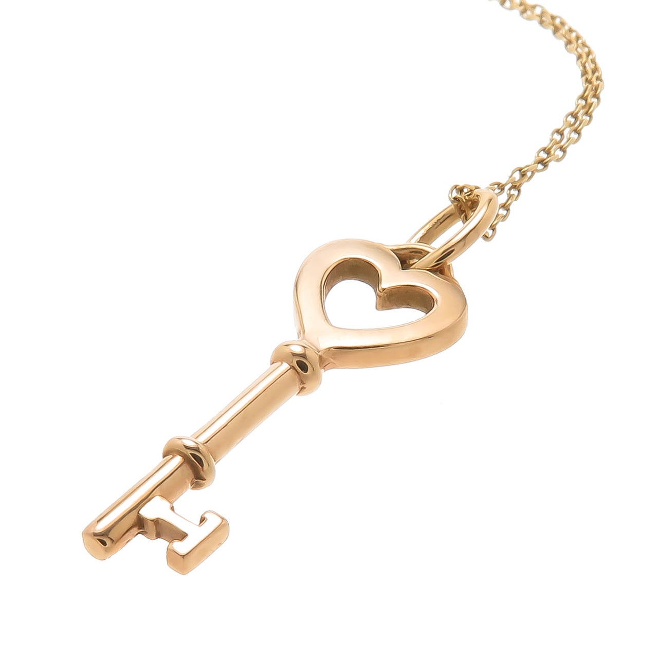 Tiffany & Company 18K Yellow Gold Key Pendant on a 20 inch Chain. Key measuring 1 1/8 Inch. Original Tiffany Presentation Box.