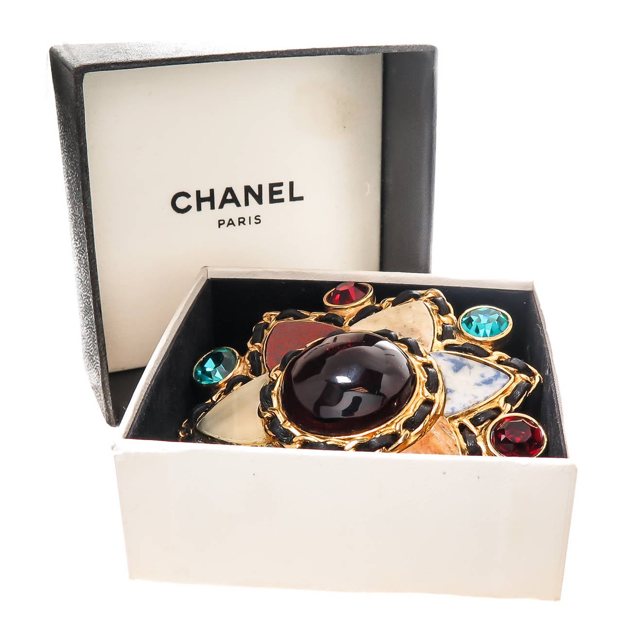 Chanel Large Gripoix Glass, faceted crystal and stone set Clip brooch, in a 6 point star motif with woven black leather around the border. Original Presentation Box. Measuring 3 inch in diameter.