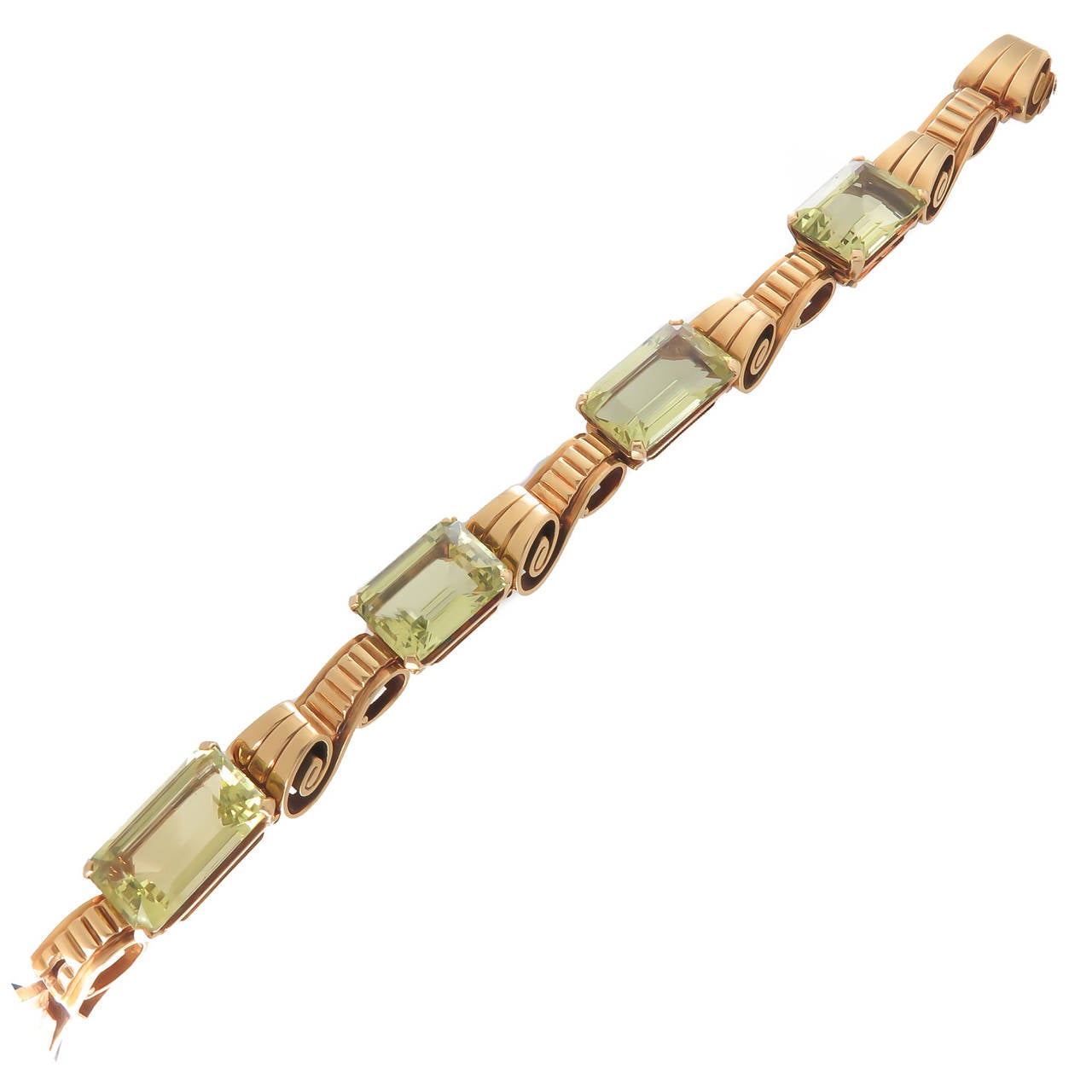 Circa 1940s Tiffany & Company 18K yellow Gold and Emerald / Stepped cut Green Quartz Gem stones. Nice heavy Retro Scroll design with each stone being slightly different is size and measuring 10 to 12 carats each. total length 7 1/4 Inch.
