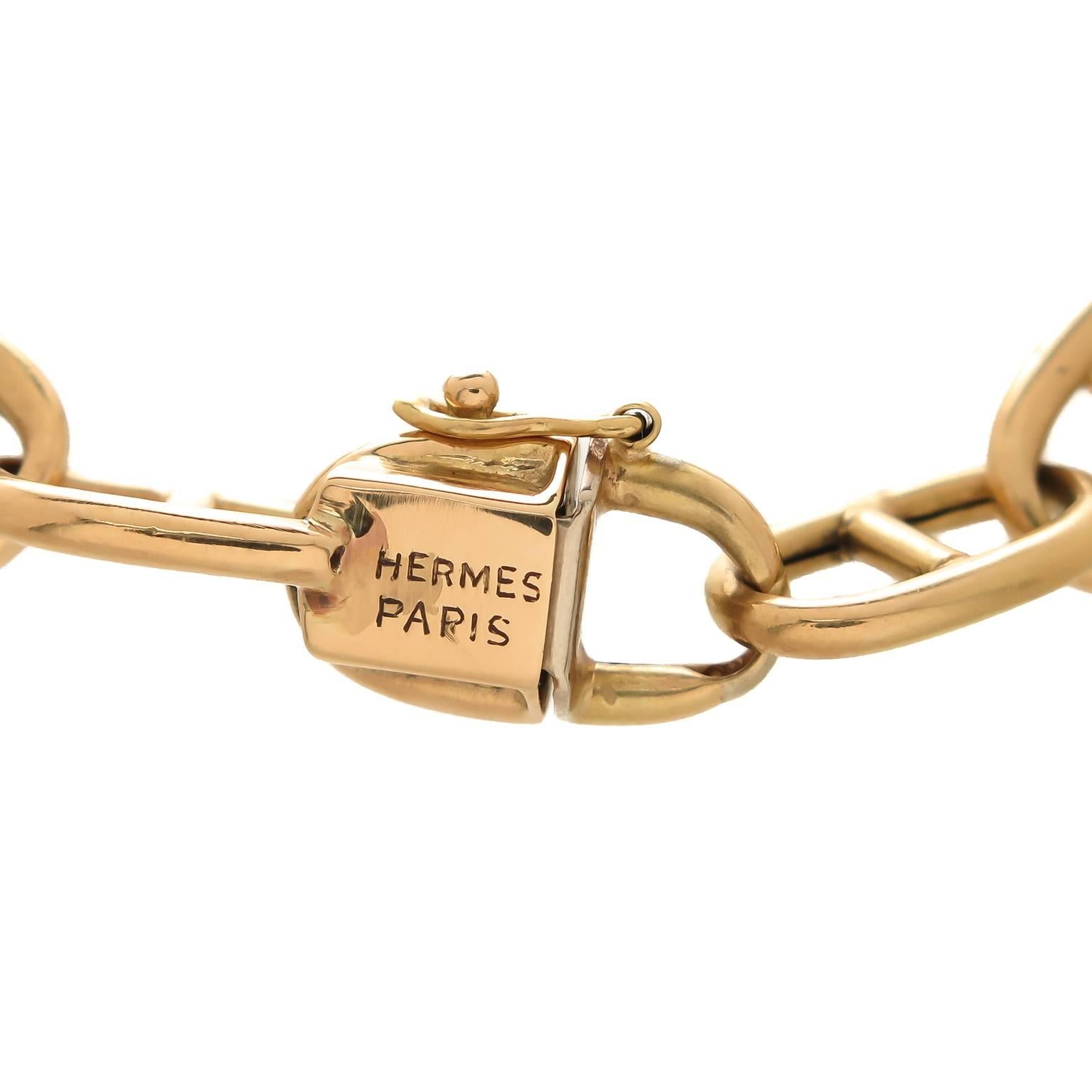 Circa 1960s Hermes Paris, 18K yellow Gold Anchor Link Bracelet, measuring 7 3/4 inch in length and 5/16 inch wide. Solid links, tongue clasp with a safety and a Cabochon Sapphire push piece. Signed and bearing French Hall Mark. 