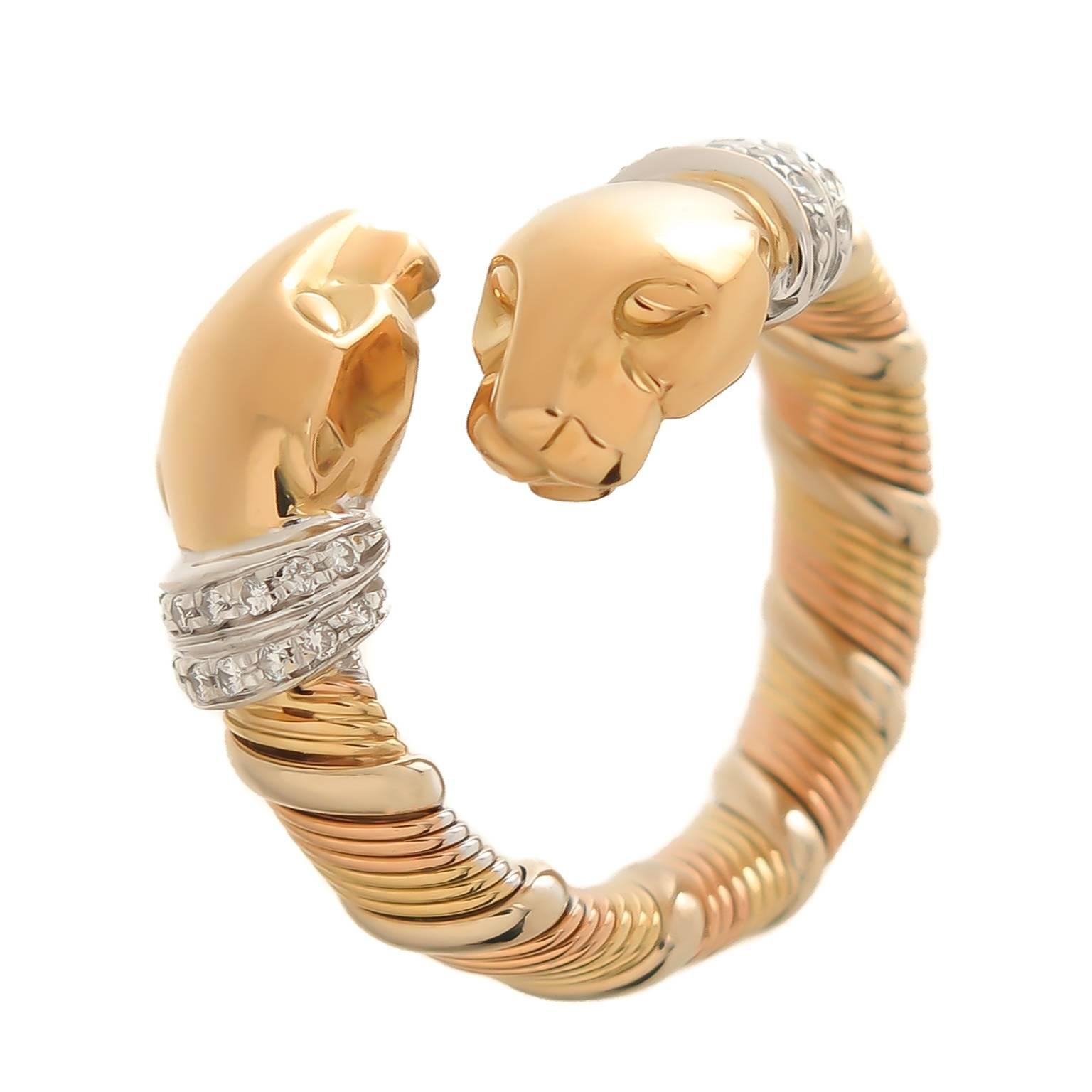 Circa 1990s Cartier 18K Yellow and White Gold Double Headed Panther Ring and further set with Diamonds in the Collars around the Panthers neck. Top measures 1 inch across. Finger size = 5 and will flex to 5 1/2.  Signed, numbered and having French