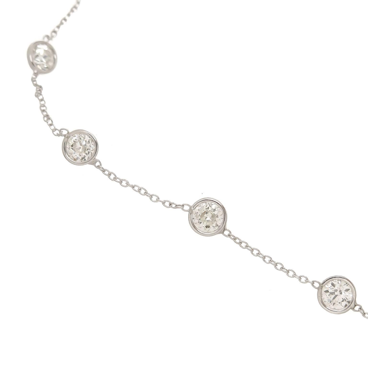 An all Platinum chain necklace set with Old European cut Diamonds, measuring 18 inch in Length the Diamonds are set 5/8 inch apart and Graduate in size from smaller to larger in the front with the larger front stones being 1/2 Carat each. Total