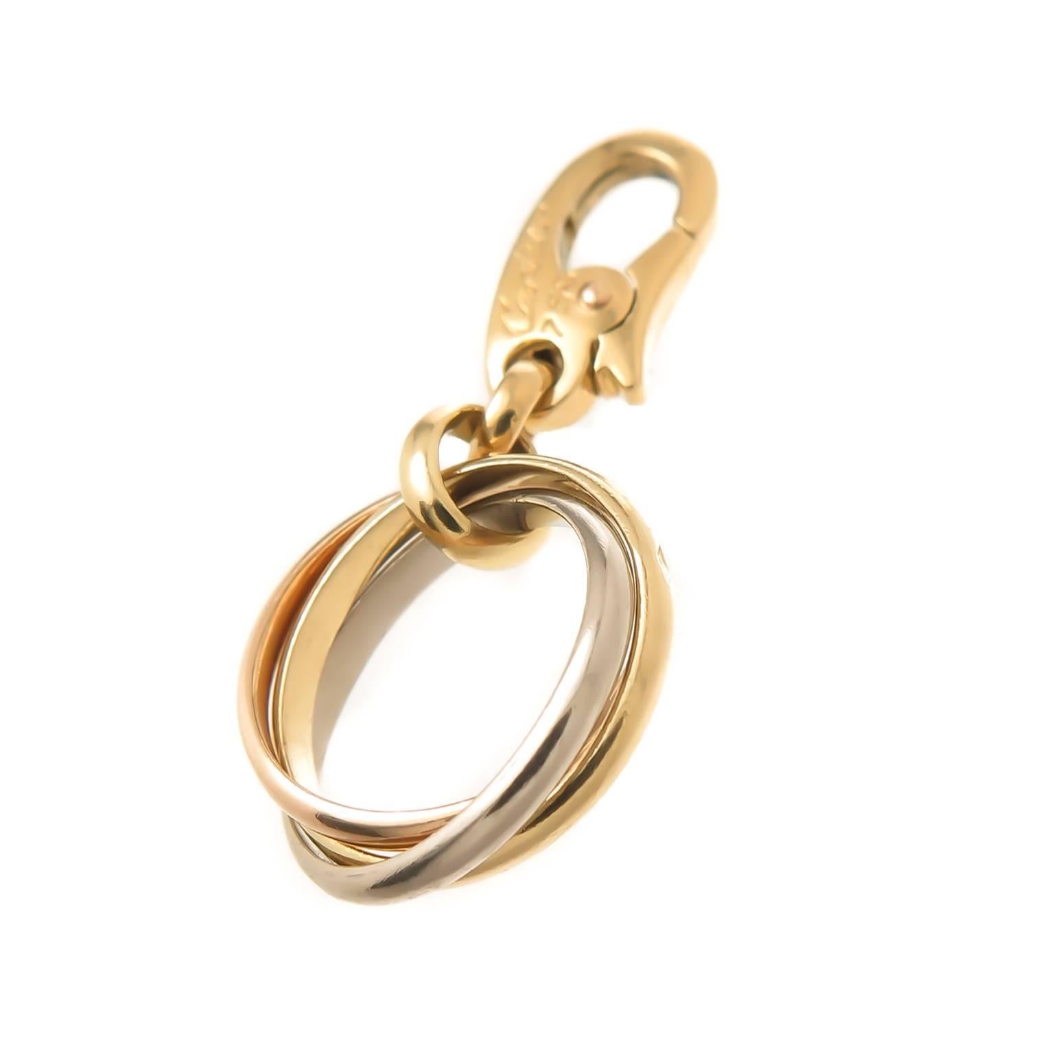 Circa 2000 Cartier 18K Yellow, Pink and White Gold Trinity Ring Charm. Measuring 1/2 inch in diameter, can be easily attached to a charm bracelet or worn as a pendant. Signed, Numbered and having French Hall Marks.
