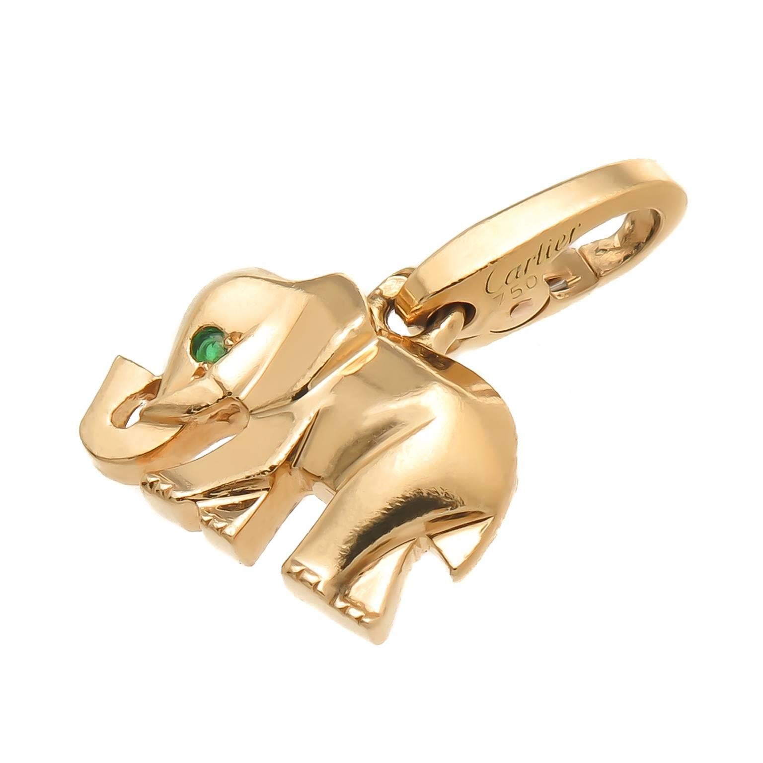 Circa 2000 Cartier 18K yellow Gold Elephant charm, measuring 1/2 X 3/8 inch and having an Emerald set in the Eye. Can be worn on a Charm Bracelet or easily detached to be worn as a pendant. Signed, numbered and having French Hall Marks.