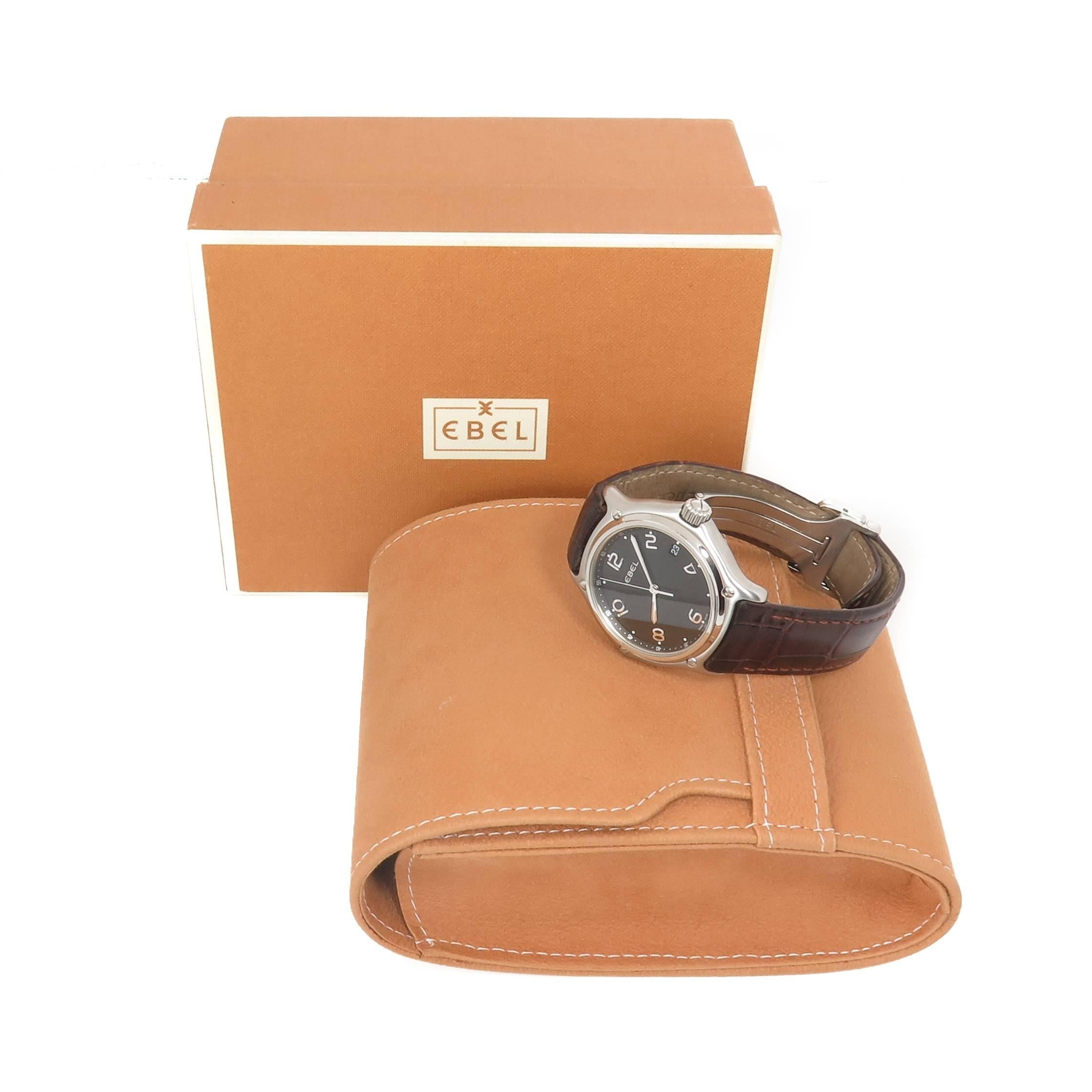 Circa 2000 Ebel 1911 collection Wrist watch, 37 MM 3 Piece Stainless Steel Water Resistant case, Quartz Movement, Black Dial with raised Markers, sweep seconds hand and a calendar window at the 3.  Brown textured strap with Ebel Steel  fold over