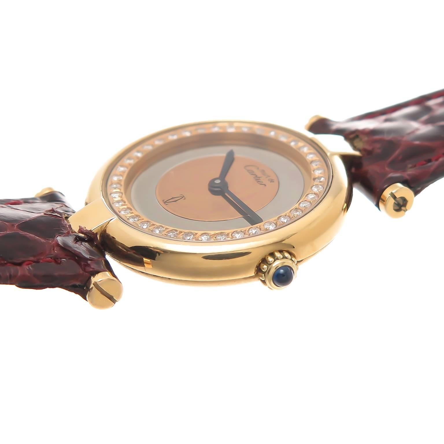 Circa 1990s Cartier Vendome Ladies Vermeil Wrist Watch with Diamonds on the inner Bezel. 24 MM Gold Plated Sterling Silver water resistant case. Quartz Movement, Sapphire Crown. Two Color Silver and Pink inner Dial surrounded by Full cut, round